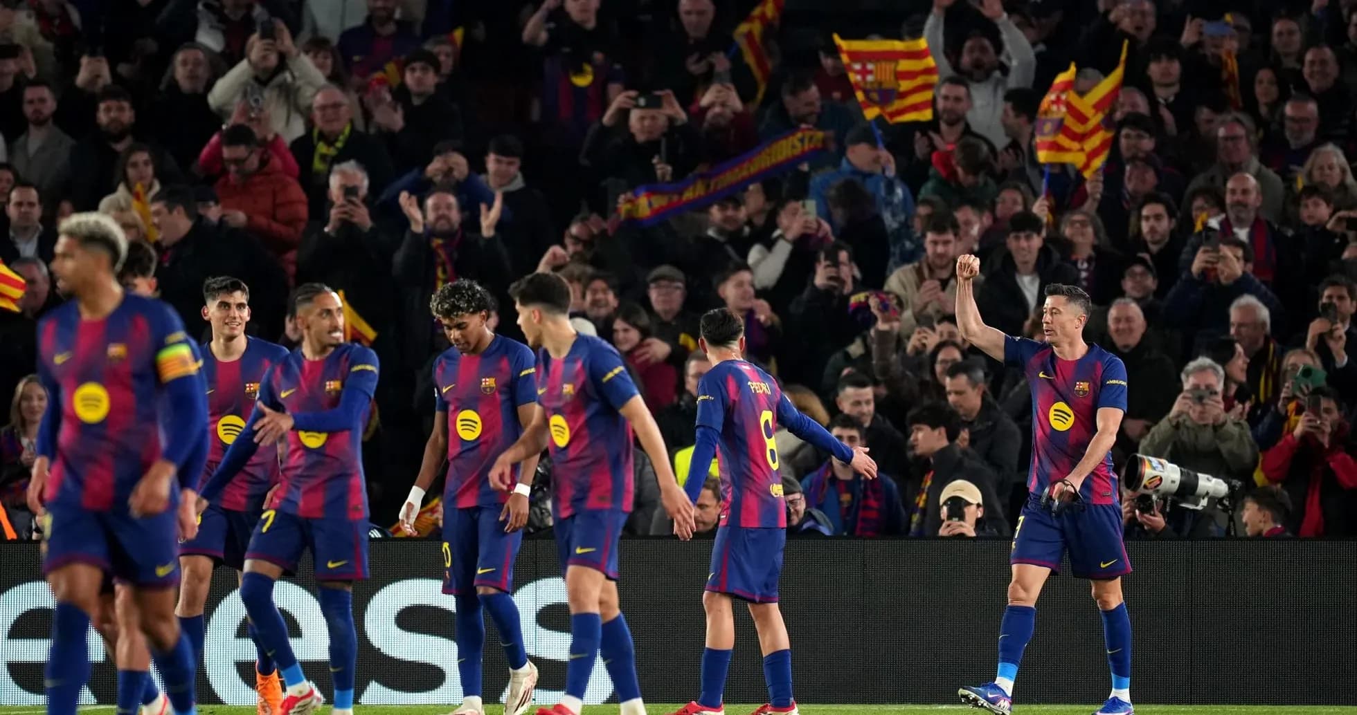 Barcelona players celebrating with fans in stadium