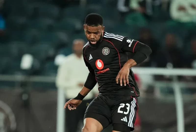 Player in black jersey dribbling the ball on field