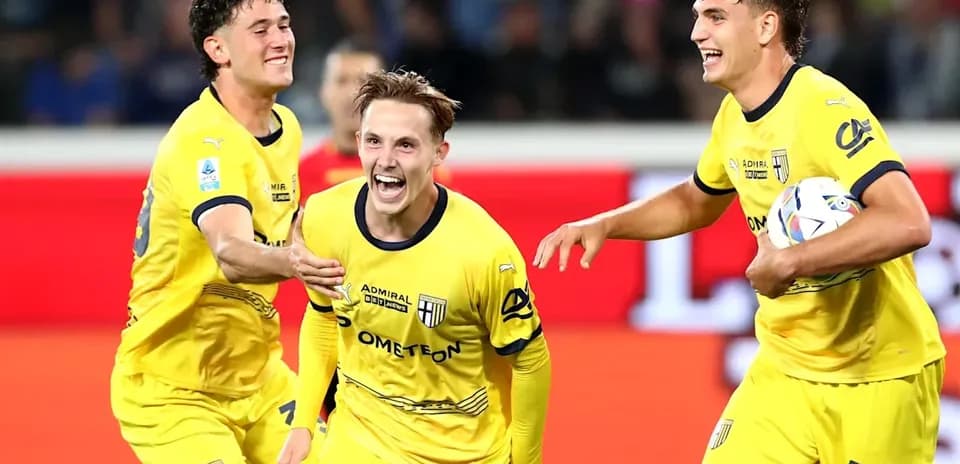 Players celebrating a goal in yellow jerseys