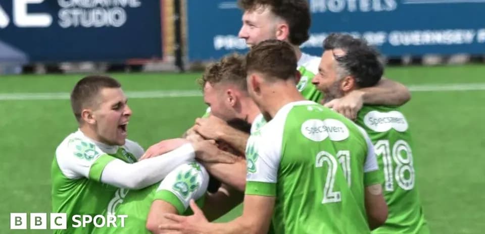Players celebrating a goal on the field