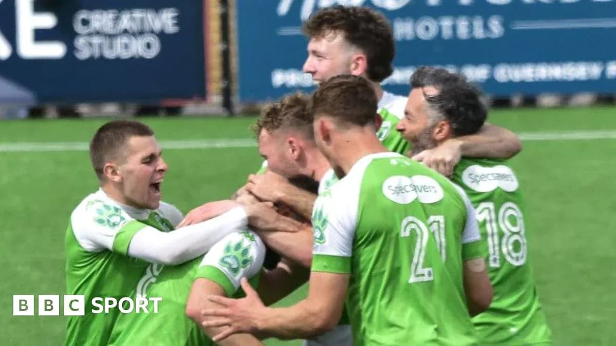 Players celebrating a goal on the field