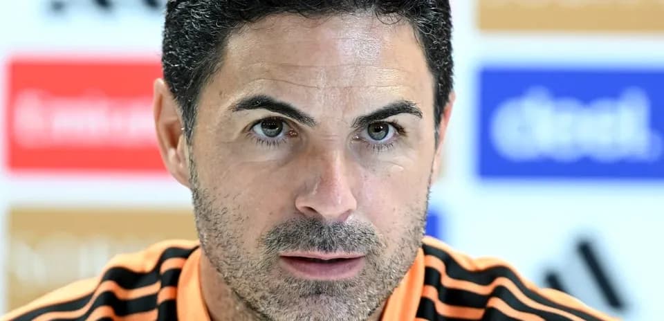 Manager speaking at press conference with intense expression