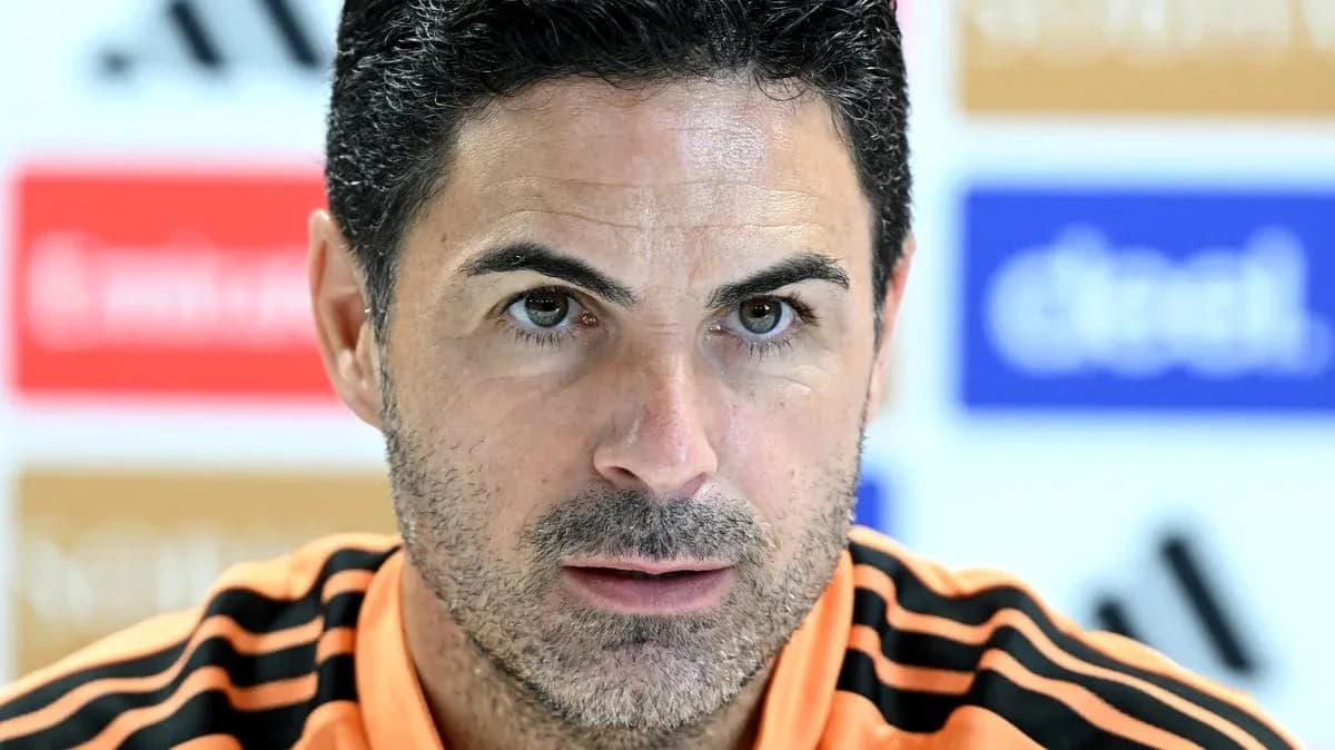 Manager speaking at press conference with intense expression