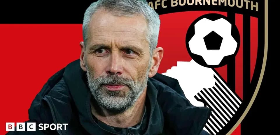 Manager in front of AFC Bournemouth logo backdrop