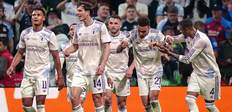 Aston Villa players celebrating a goal on the pitch
