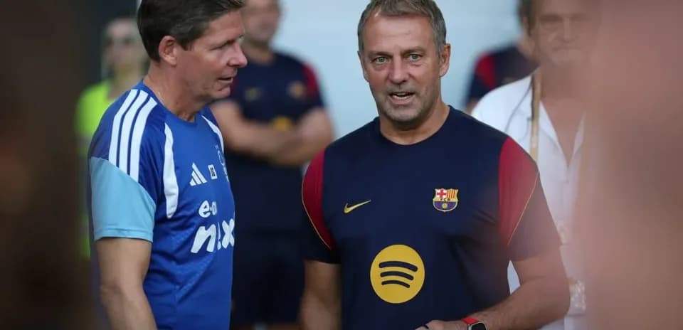 Coaches talking during Barcelona training session