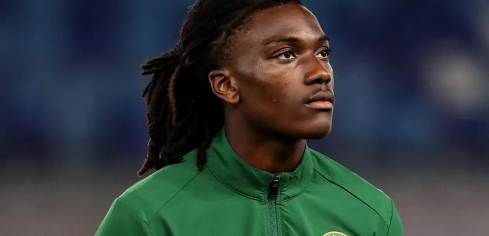 Player in green jersey looking up during match