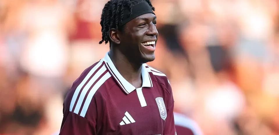 Player smiling in maroon jersey during match