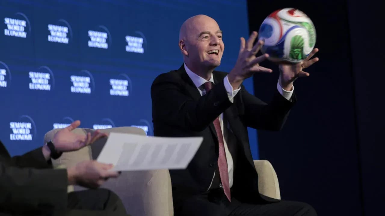 Official holding a soccer ball at conference