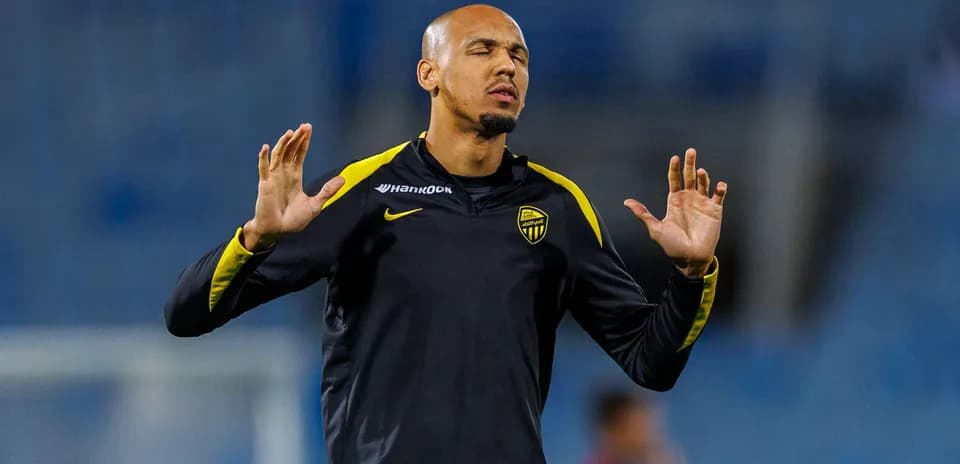 Player stretching during training session on pitch