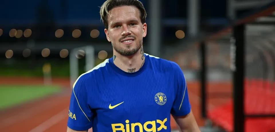 Player in blue Chelsea jersey smiling on field