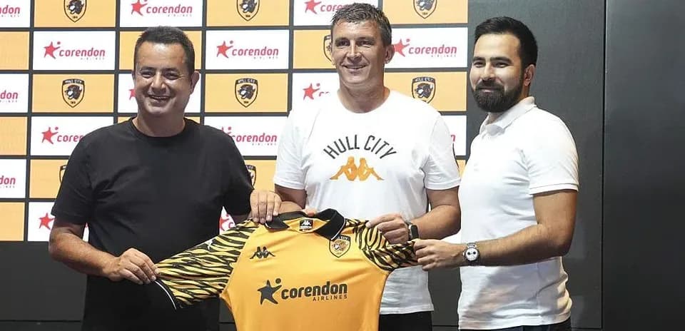 New coach presenting Hull City jersey at announcement event