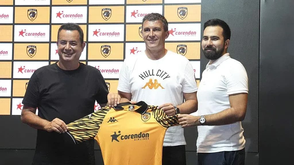 New coach presenting Hull City jersey at announcement event
