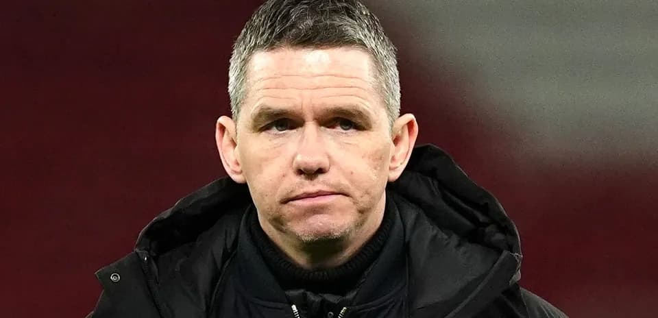 Coach in black jacket during match day