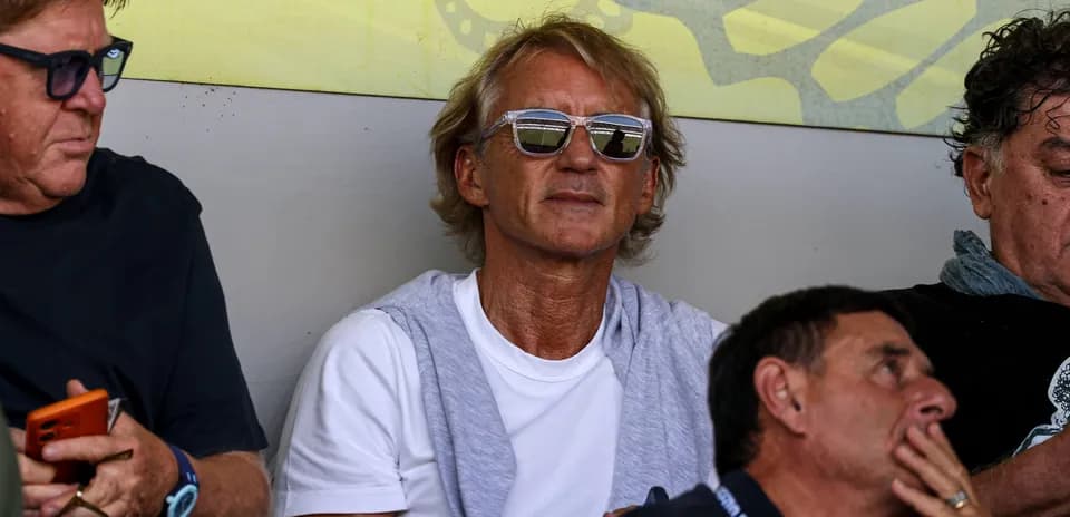 Man wearing sunglasses in stadium seating area