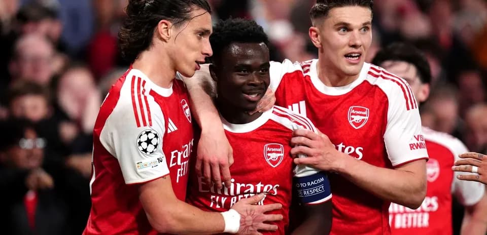 Arsenal players celebrating a goal on the field