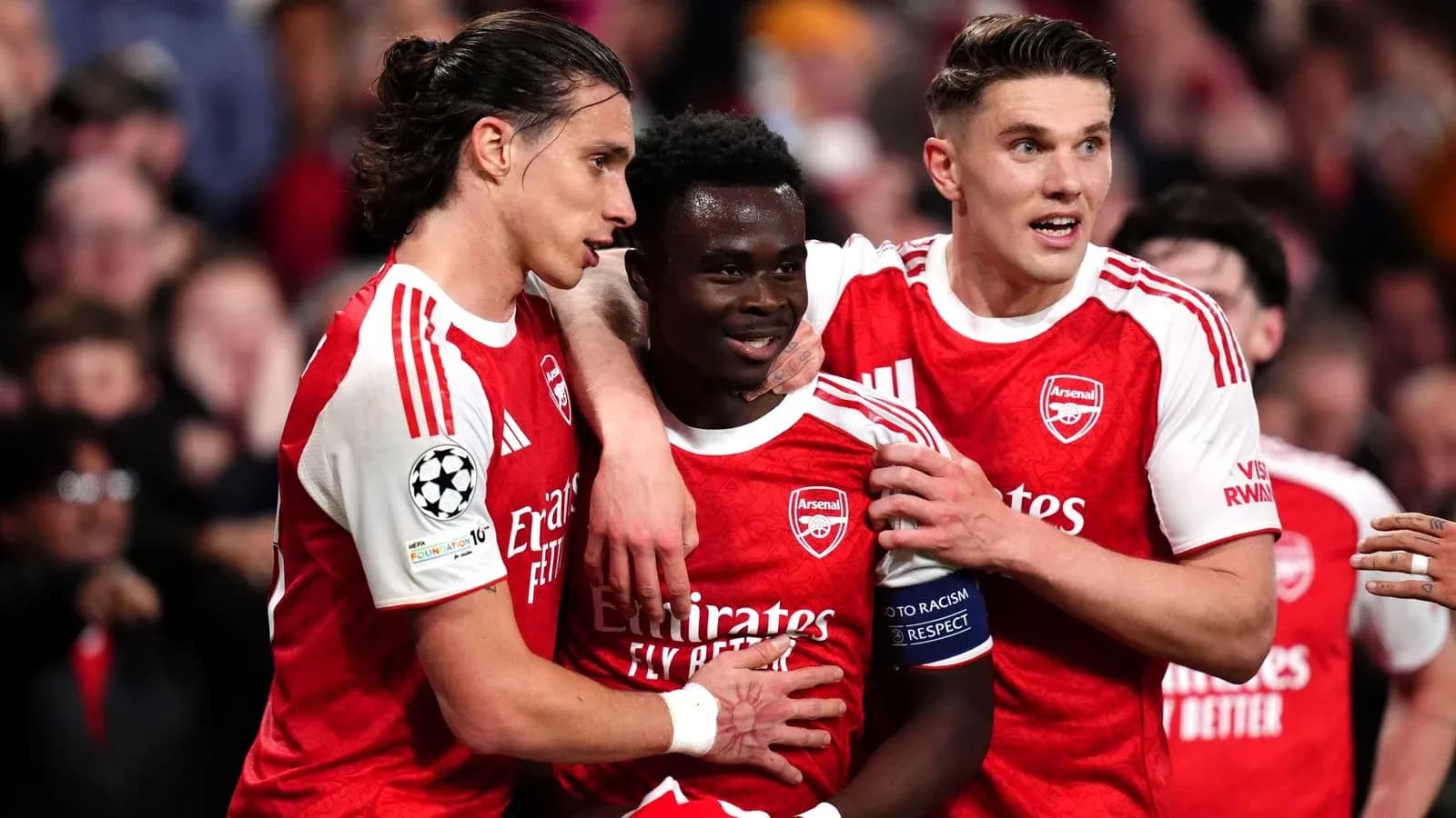 Arsenal players celebrating a goal on the field