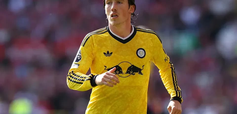 Player in yellow kit running on the field