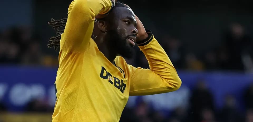 Player in yellow jersey holding head in disappointment