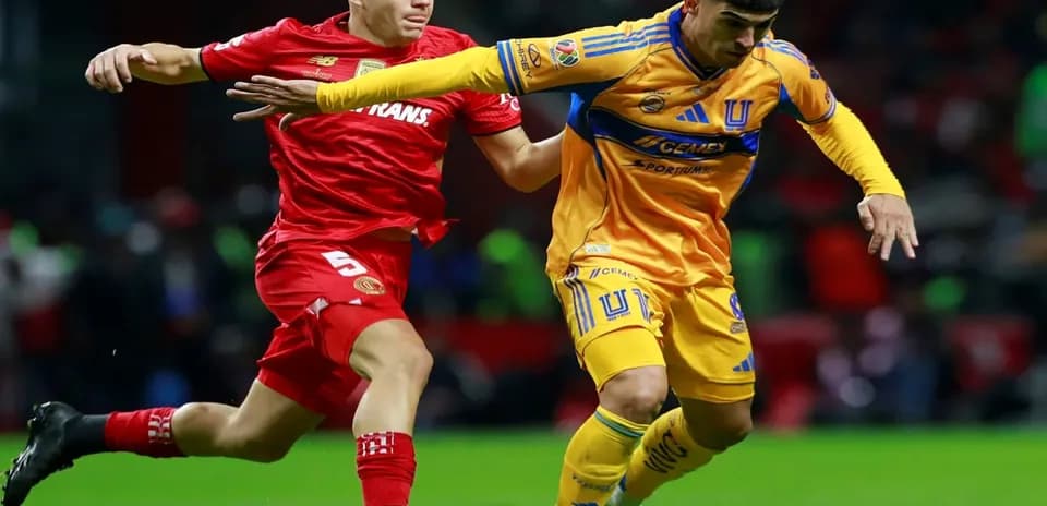 Toluca player challenges Tigres UANL player for ball