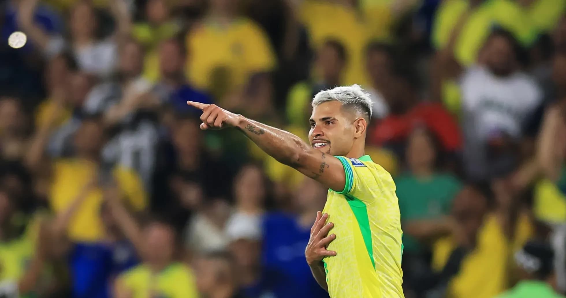 Player celebrating and pointing to crowd in stadium