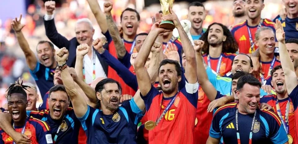 Spain team celebrating with World Cup trophy