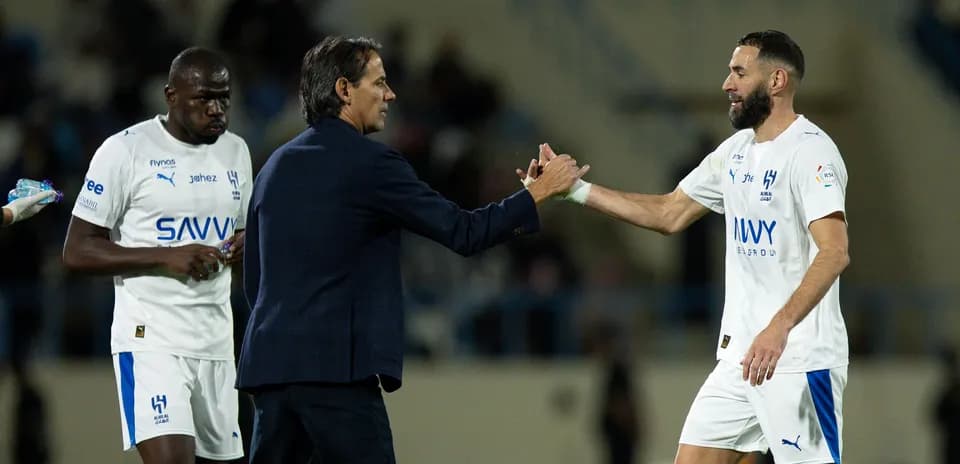 Coach shaking hands with player during match