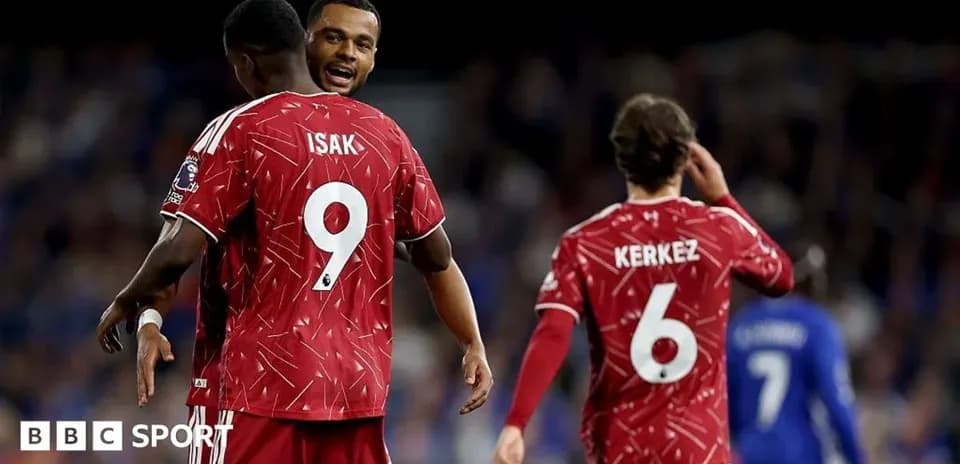 Players celebrating during a match with red jerseys