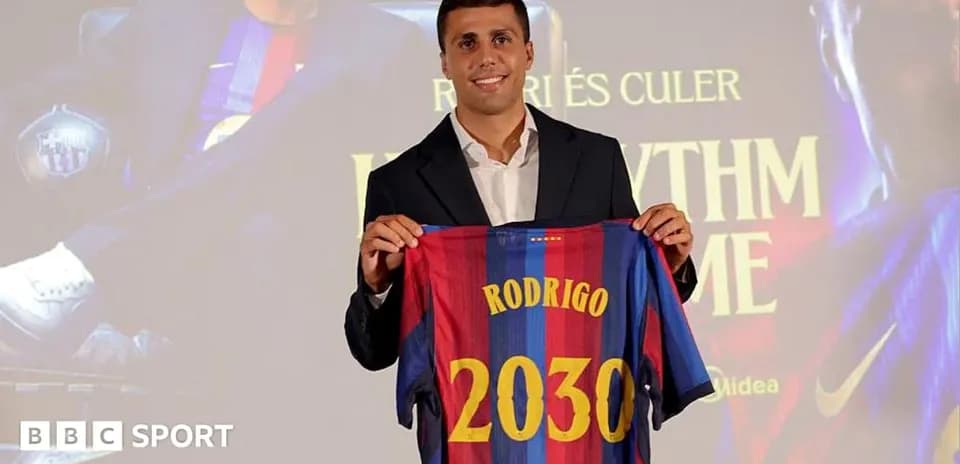 Player holding Barcelona jersey at presentation event