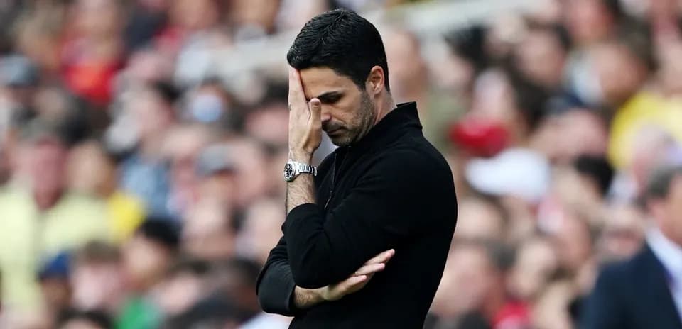 Coach with hand on forehead during match
