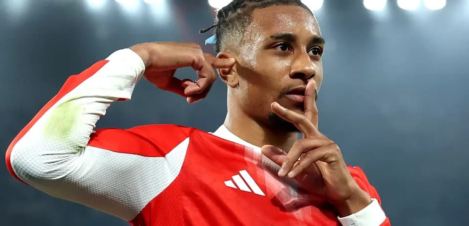 Player celebrating with finger to lips in stadium