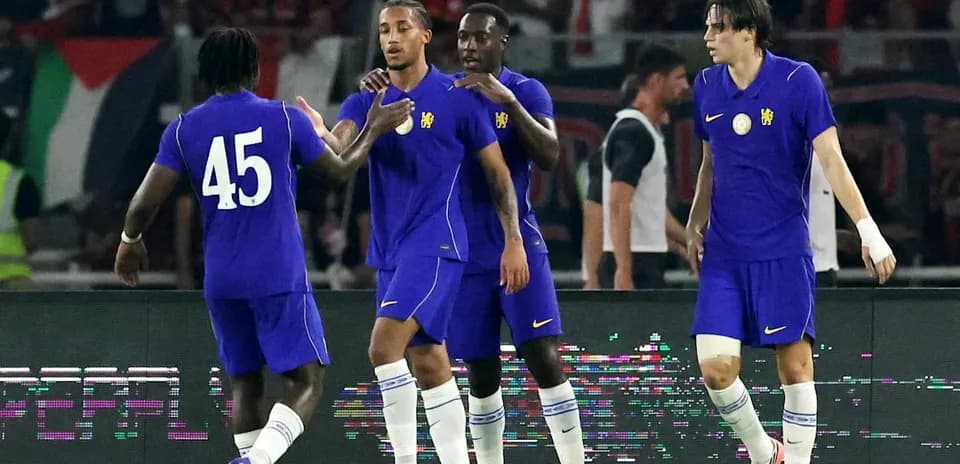 Players celebrating on the field in purple uniforms