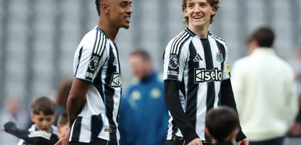 Two Newcastle players interacting during warm-up session