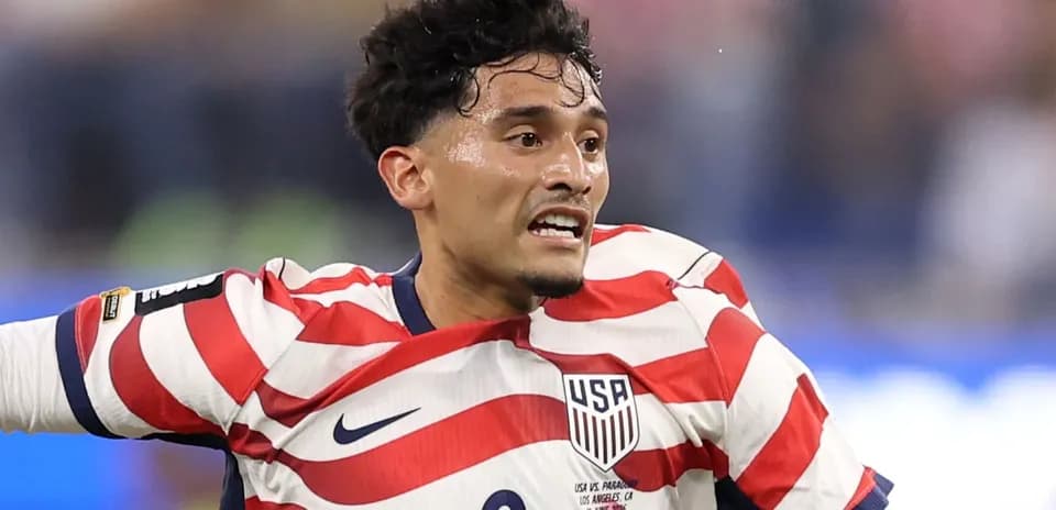 Player in striped USA jersey during match action