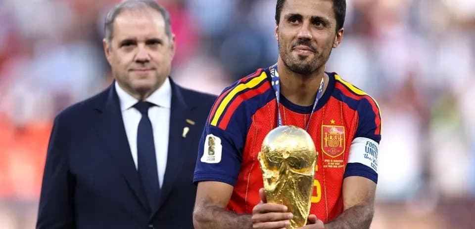 Player holding World Cup trophy on podium