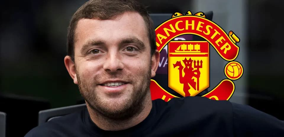 Man smiling with Manchester United logo background