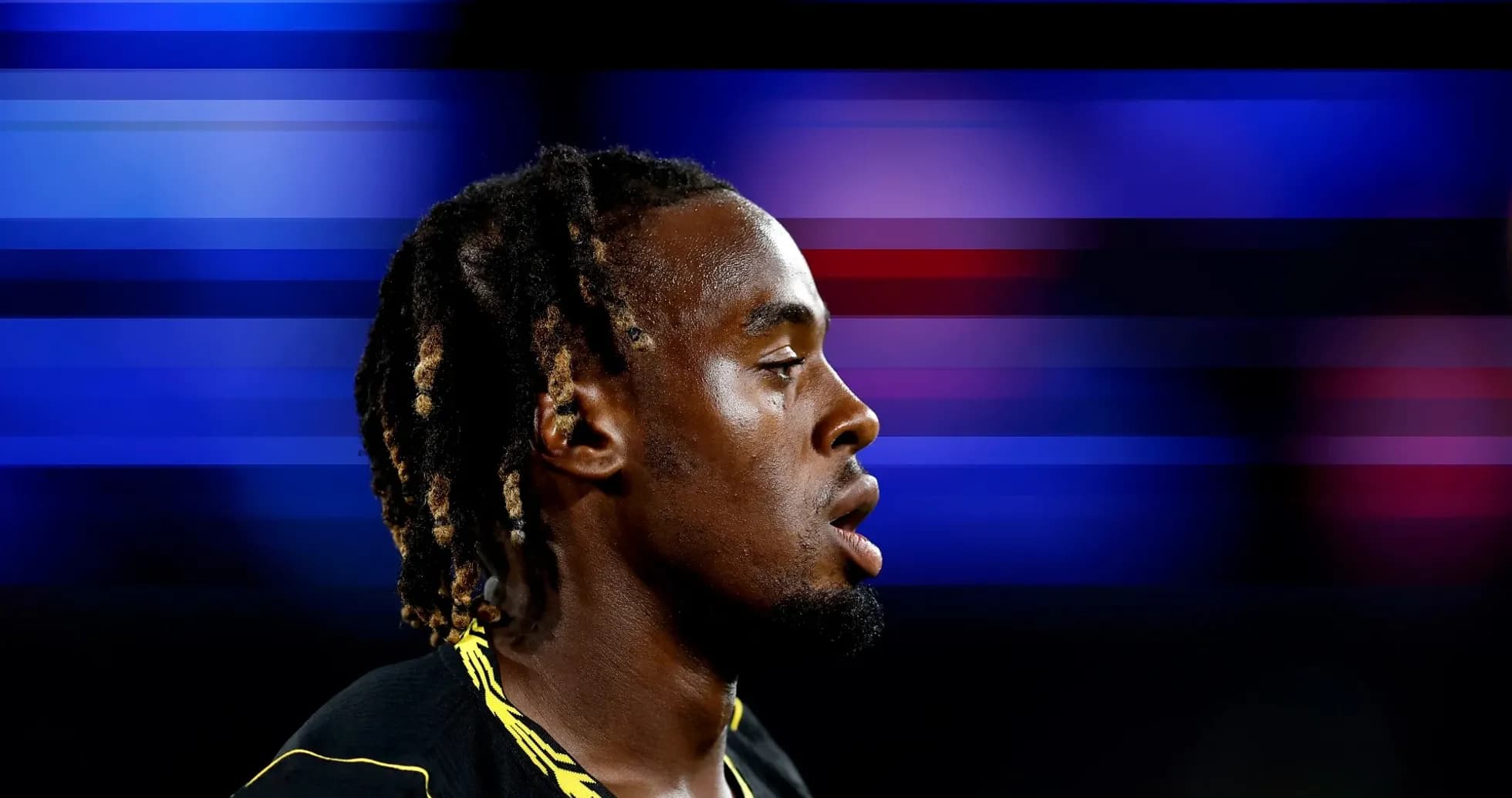 Athlete in profile against a colorful blurred background