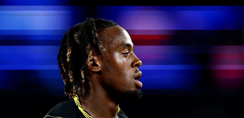 Athlete in profile against a colorful blurred background
