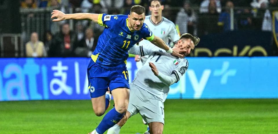 Player from Bosnia colliding with Italian defender