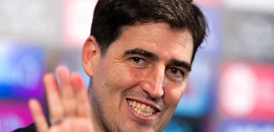 Manager waving during a press conference appearance