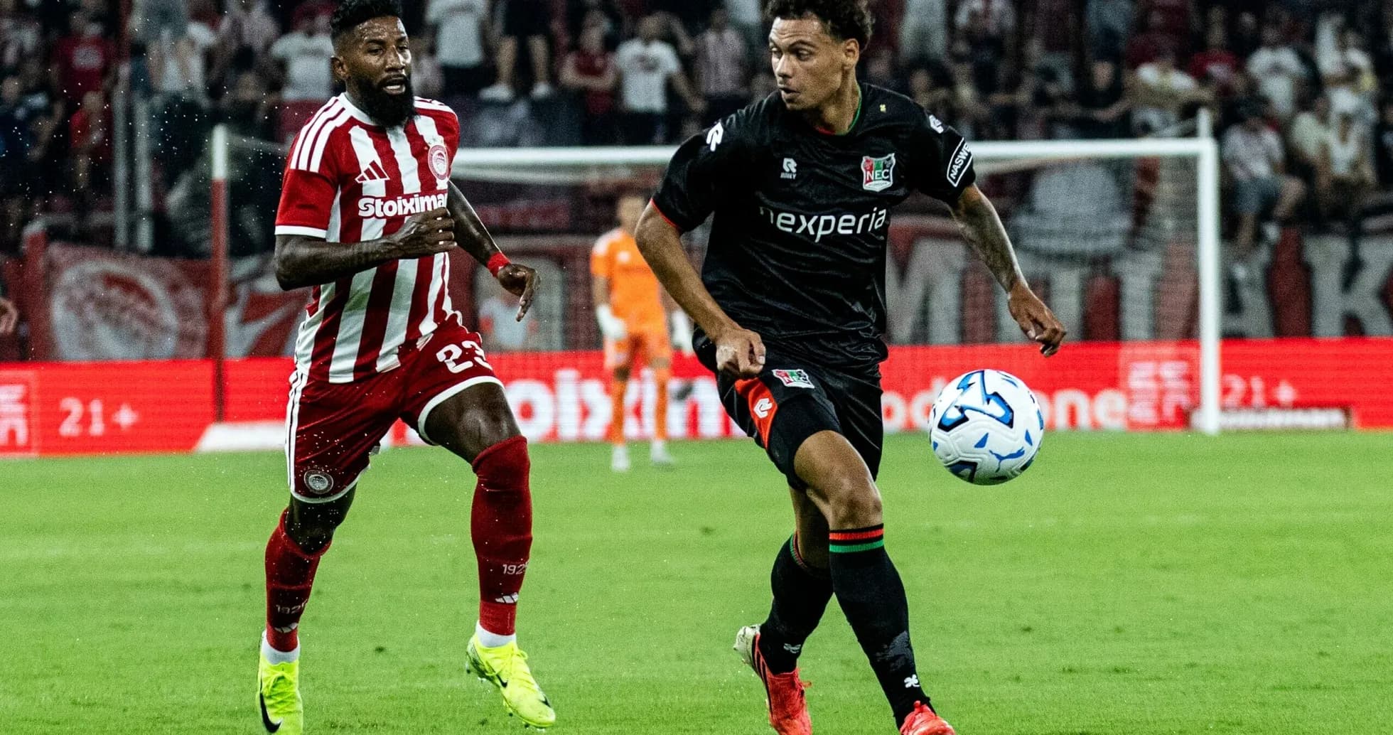 NEC player dribbling past Olympiakos defender