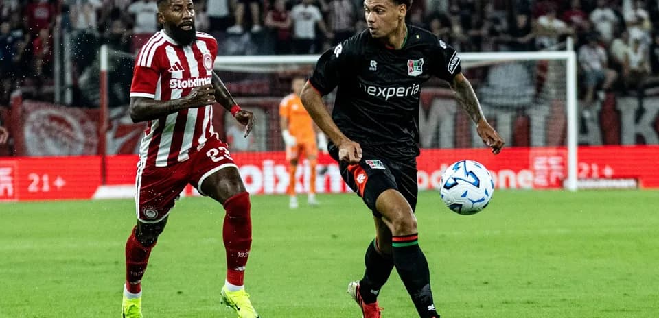 NEC player dribbling past Olympiakos defender