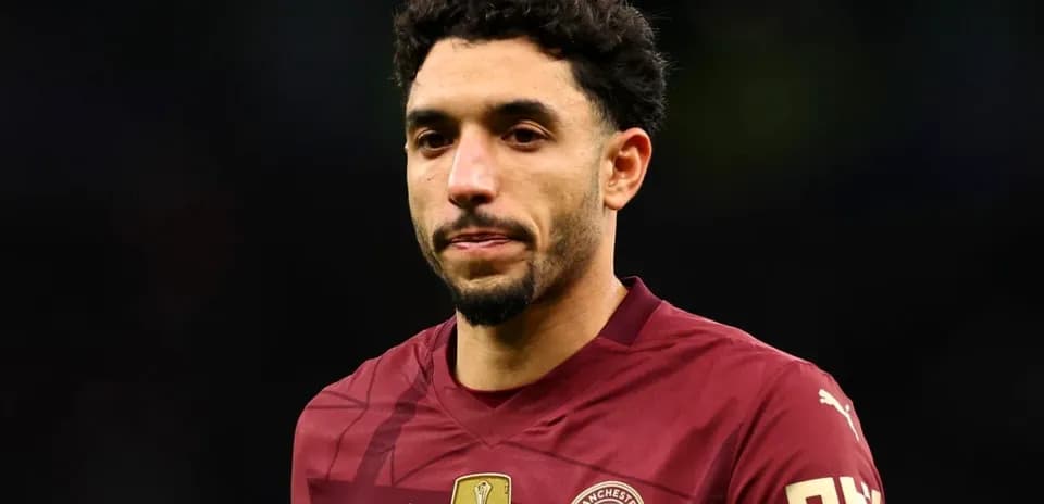 Player in maroon Manchester City jersey during match