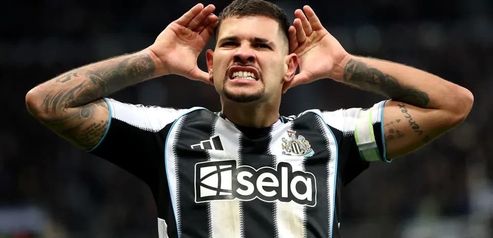 Newcastle player celebrating with hands on ears