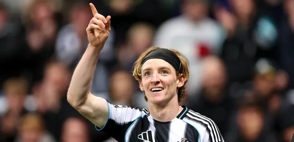Newcastle player celebrating and pointing after scoring