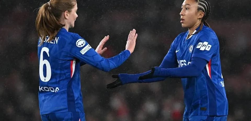 Two Chelsea players exchanging greetings on the field