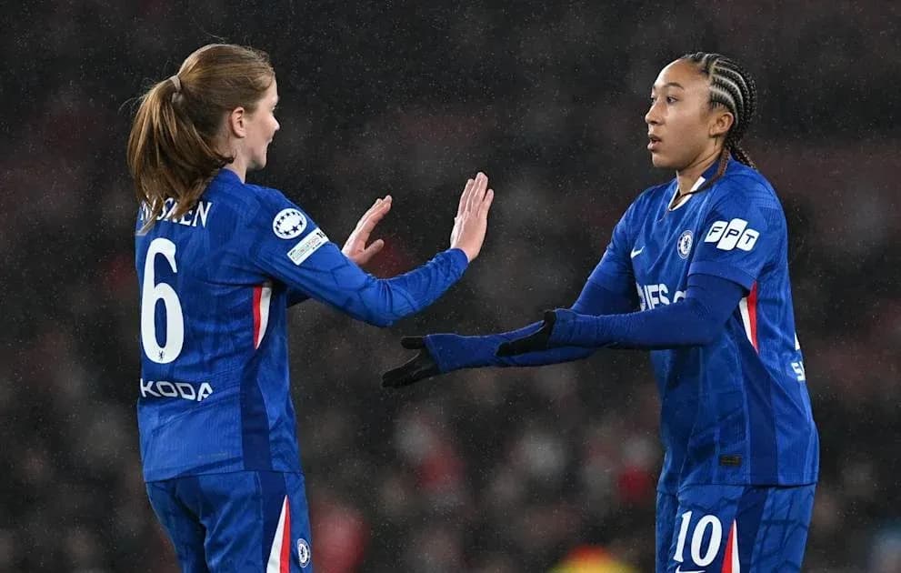 Two Chelsea players exchanging greetings on the field