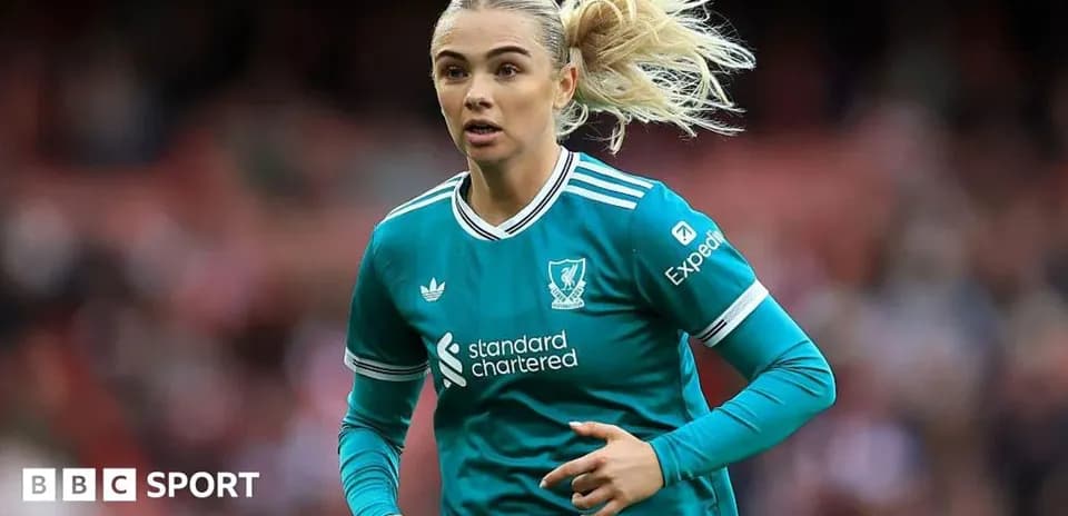 Female football player in Liverpool kit running
