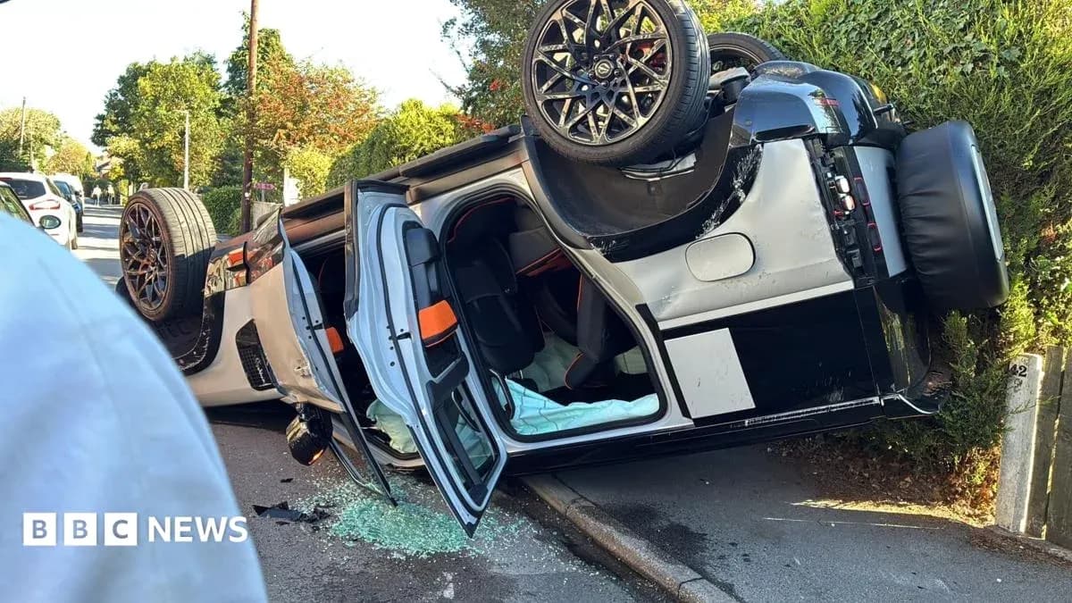 Upside-down sports car with shattered glass on road Upside-down sports car with shattered glass on road