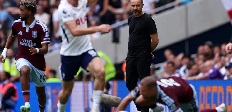Aston Villa player dribbling past Tottenham defenders